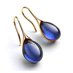 Gold drop earrings with smooth crystal