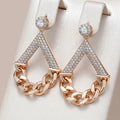 Elegant earrings with gold-shimmering chains
